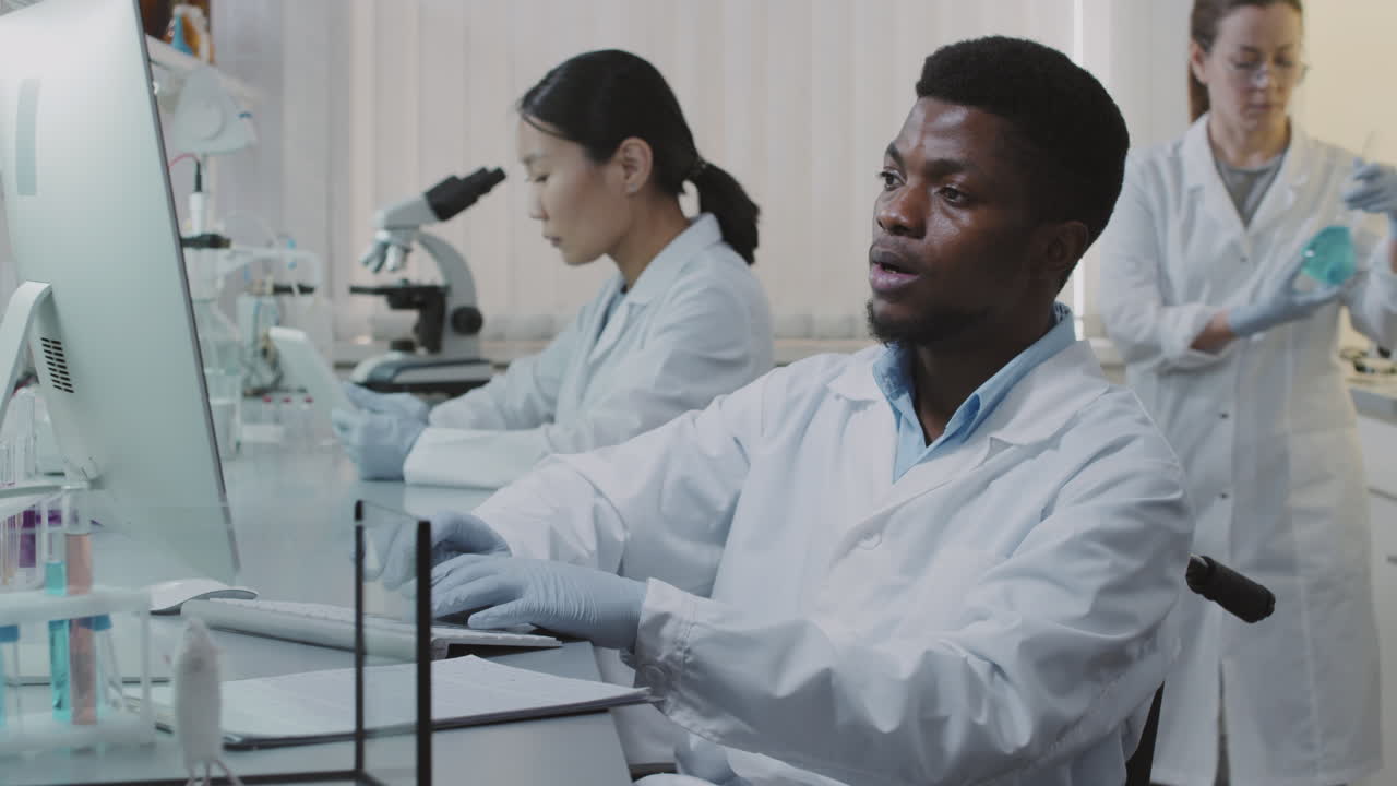 Disabled Male Scientist Working in Lab