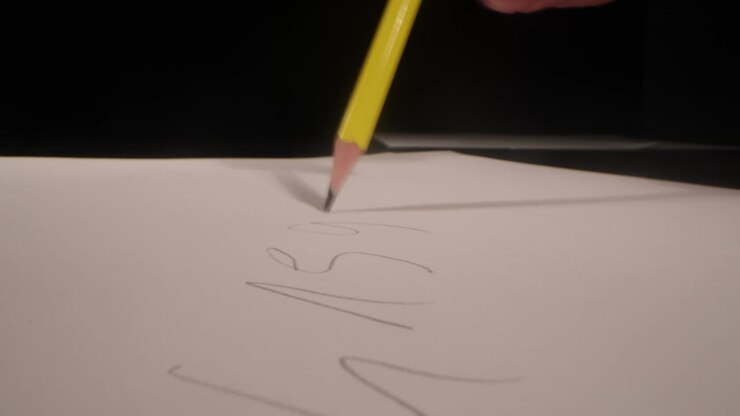The number pi is written with a pencil on a white sheet. Concept of the number of days Pi. pi is 3.14 . Pi day number concept. pi is 3.14. Close up