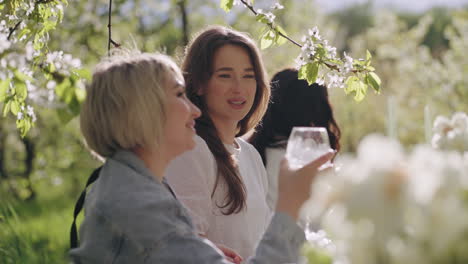 happy women are having fun in garden party ladies are chatting joyfully enjoying cocktails