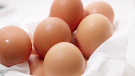 organic fresh several eggs in a rotating container on white wrapping paper for making food