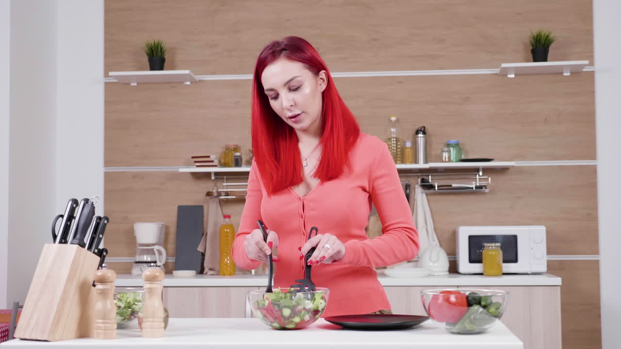 Woman and girl preparing salad in kitchen