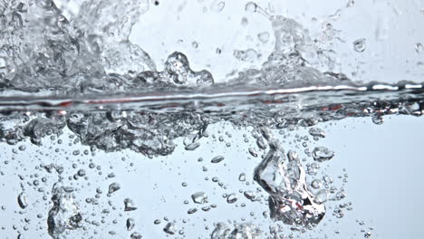 closeup red peaches falling down water with drops. juicy fruit throw at vessel