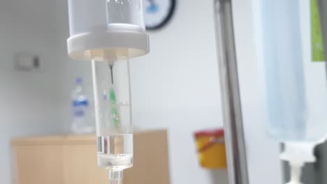 close up of hanging medical iv with slow drip