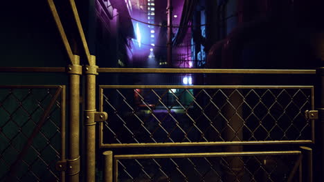 dimly lit urban alley with a chain link fence at night