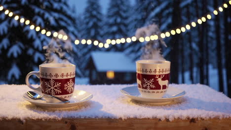 warm drinks by the cabin in the snow