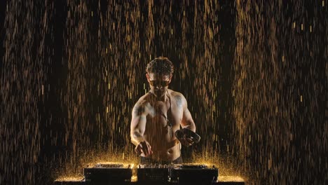 dj performance under golden rain