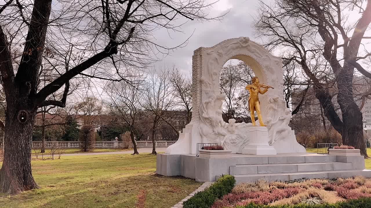 Golden statue of Johann Strauss playing violin in Stadtpark Vienna Austria
