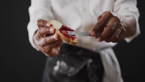 video of cook grease bread with butter on black background