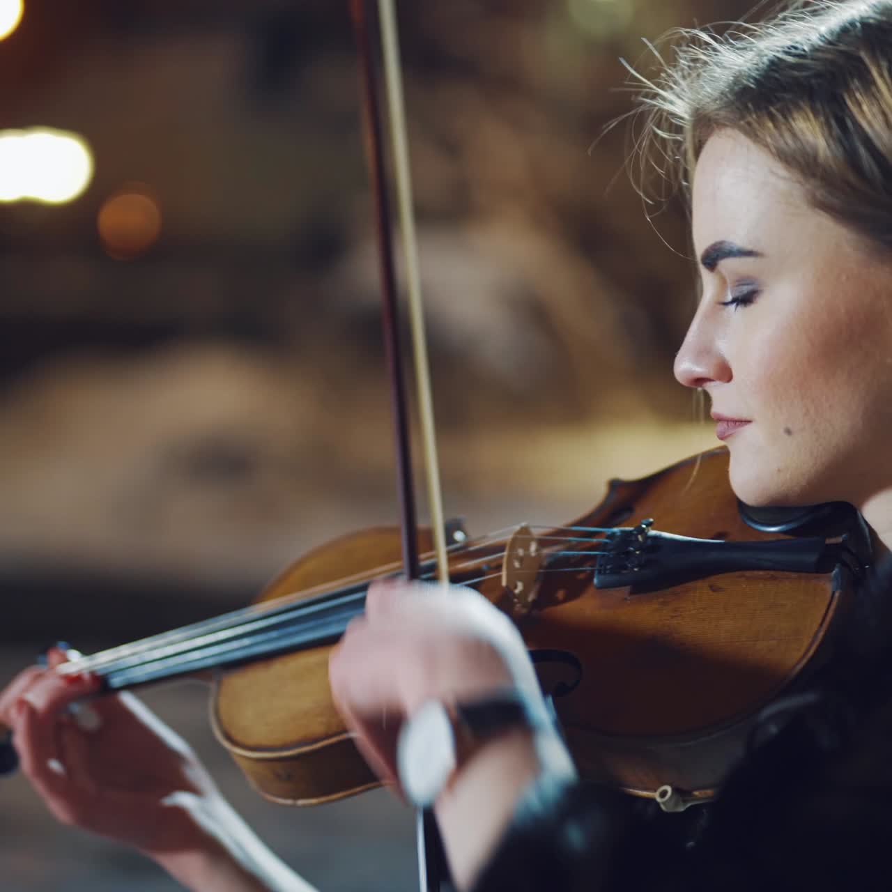Romantic girl playing on violin at winter park