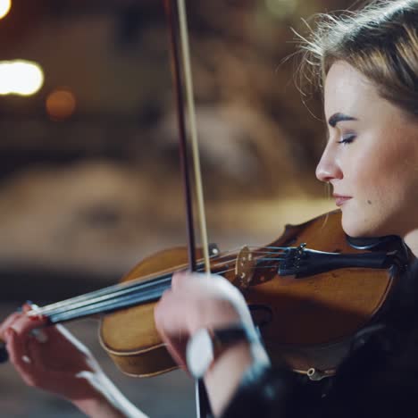 romantic girl playing on violin at winter park
