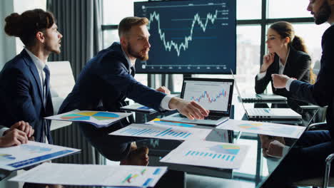 business professionals collaborating and analyzing financial data in a modern office meeting