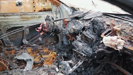closeup of destroyed dashboard and burnt wreckage inside car after fire, latvia
