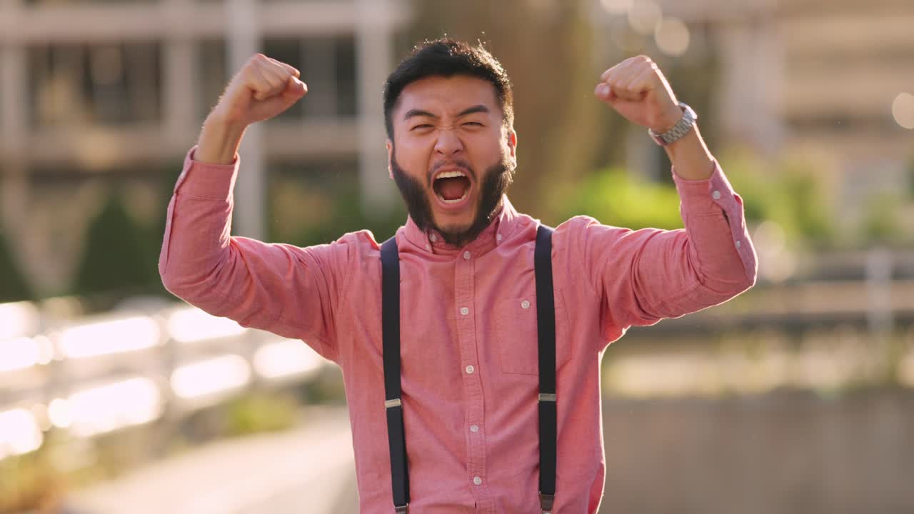 Excited Young Man Cheering and Celebrating Success