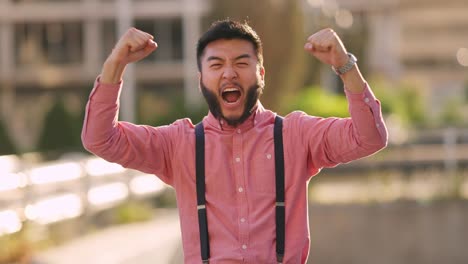 excited young man cheering and celebrating success