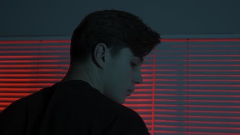 person looking out window at night