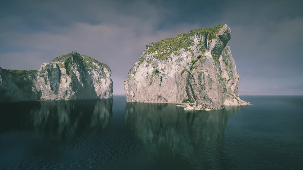 Dramatic cliff silhouette above peaceful reflective waters using muted colors