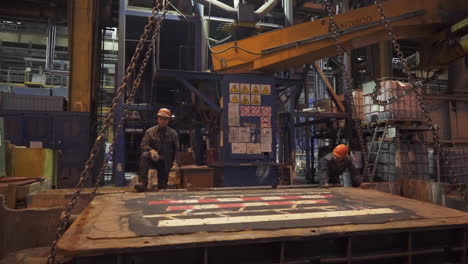 metal casting factory workers at work