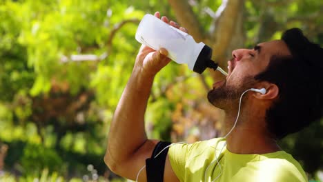 male jogger drinking water from bottle 4k