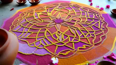 colorful rangoli design with candles