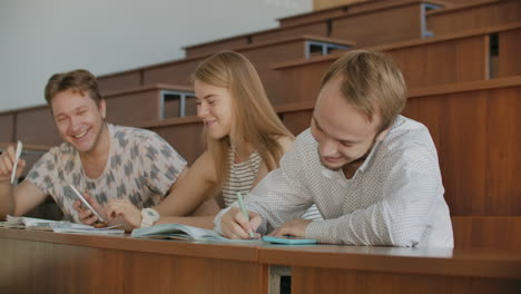 Die-Gruppe-Fröhlicher,-Glücklicher-Studenten,-Die-Vor-Dem-Unterricht-In-Einem-Hörsaal-Sitzen.-Die-Gruppe-Fröhlicher-Studenten,-Die-Vor-Dem-Unterricht-In-Einem-Hörsaal-Sitzen.