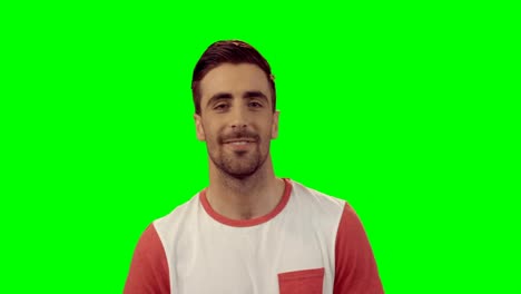 Smiling-man-standing-against-green-screen