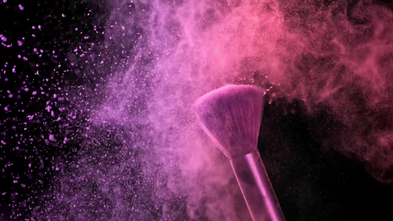 Vibrant Pink and Purple Powder Exploding from Makeup Brush