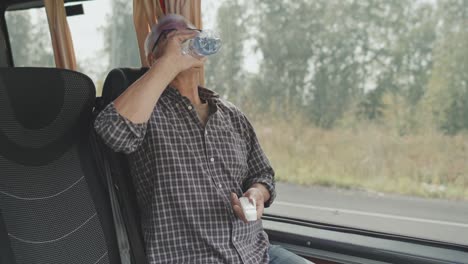 senior man taking medicines in bus