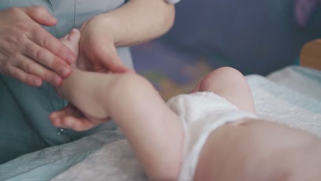 pediatrician-rubs-and-massages-adorable-infant-legs