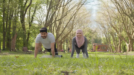 couple exercising in park