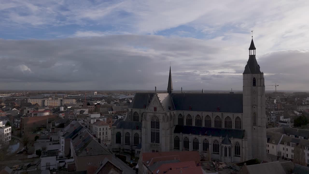 Drone shot of a church in a city center on a cloudy day before sunset.