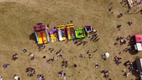 ascending top down shot colored inflatable games for kids outdoors in sunlight