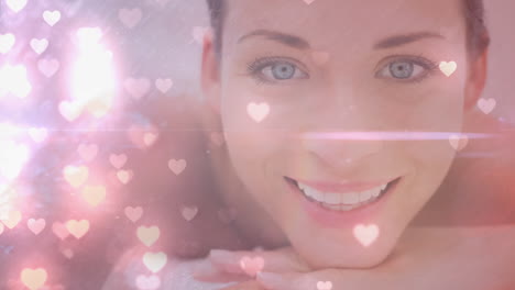 woman lying on a massage table smiling