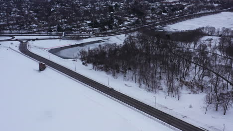 an aerial view from a drone, over a frozen lake during sunrise on a cloudy morning