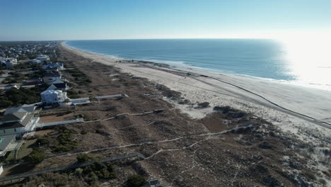 drone shot of beach nourishment, or adding sand or sediment to beaches to combat erosion, can have negative impacts on wildlife and ecosystems, with water coming out of pipe