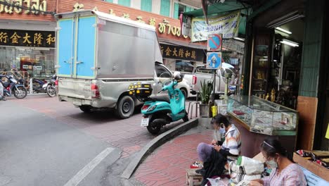 truck moves through crowded urban area