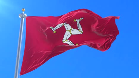 flag of the isle of man waving at wind in slow in blue sky, loop