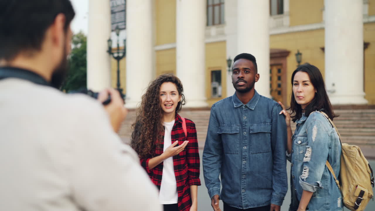 Friends taking pictures in front of a building