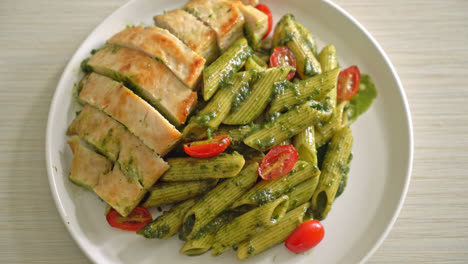 homemade penne pasta in pesto sauce with grilled chicken