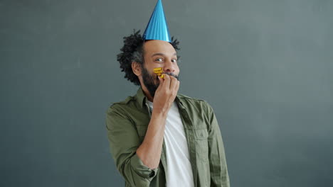 man with party hat and horn