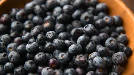 close up of fresh blueberry in wooden plate