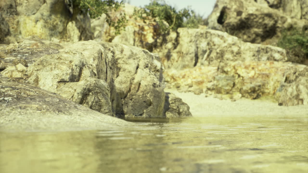 Serene coastal landscape with clear water reflecting rocky shore