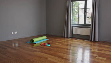 empty home workout room with yoga mat and resistance bands