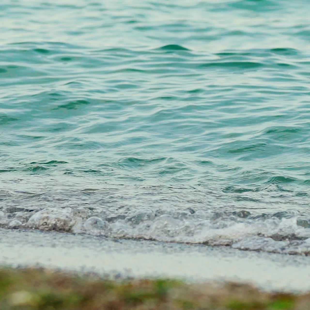 Sea waves on black sand beach. Slow motion