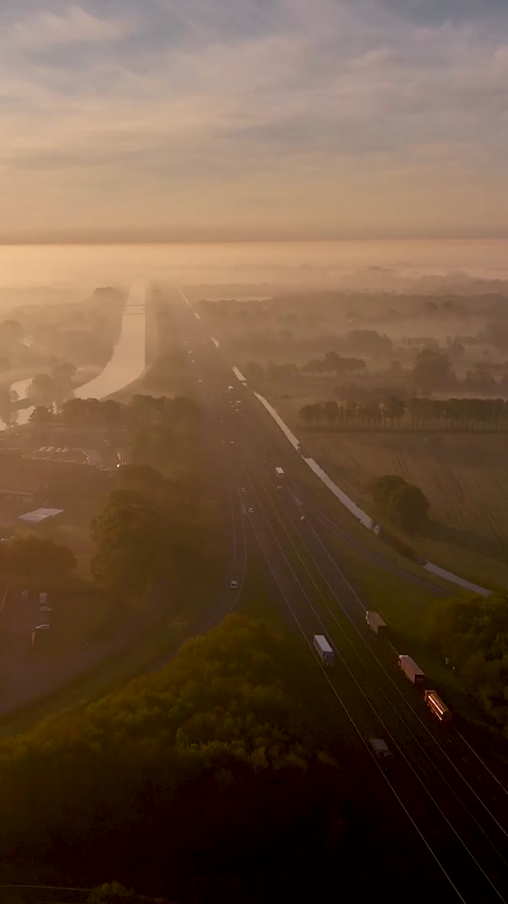 Highway through Foggy Sunrise Landscape