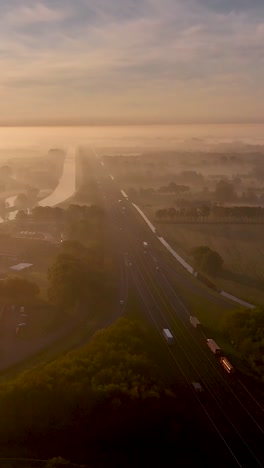 highway through foggy sunrise landscape