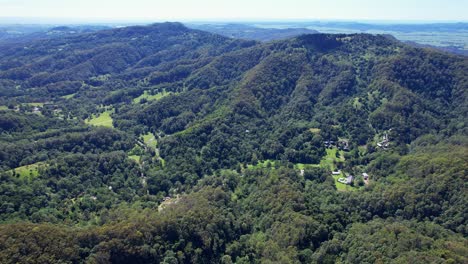 lush green forest and mountains of currumbin valley in gold coast, queensland, australia - aerial drone shot
