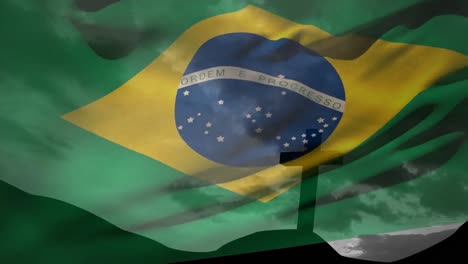 Animation-of-waving-brazil-flag-against-silhouette-of-cross-crucifixion-on-a-mountain