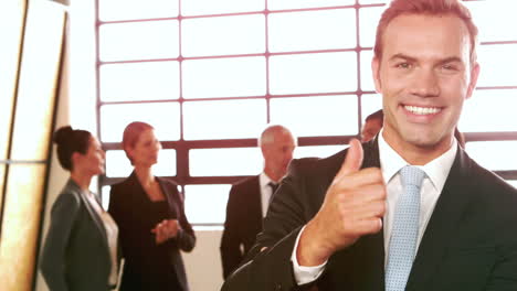 smiling businessman with thumbs up