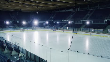 empty professional ice hockey rink arena with lights turning on. big stadium ready for the championship to begin. high quality venue ready to fit thousands of fans enjoy the game. establishing shot