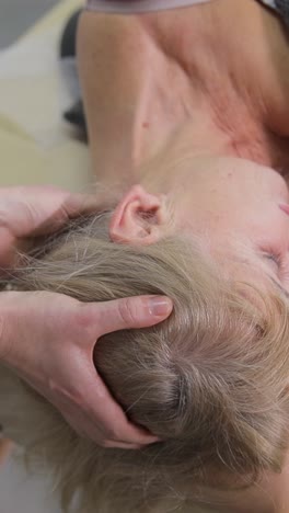 neck massage session for elderly woman